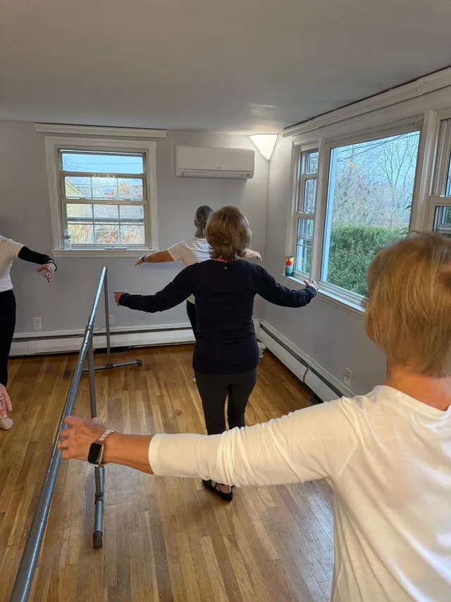 Adult ballet students training at the barre in the VW Dance studio in South Weymouth