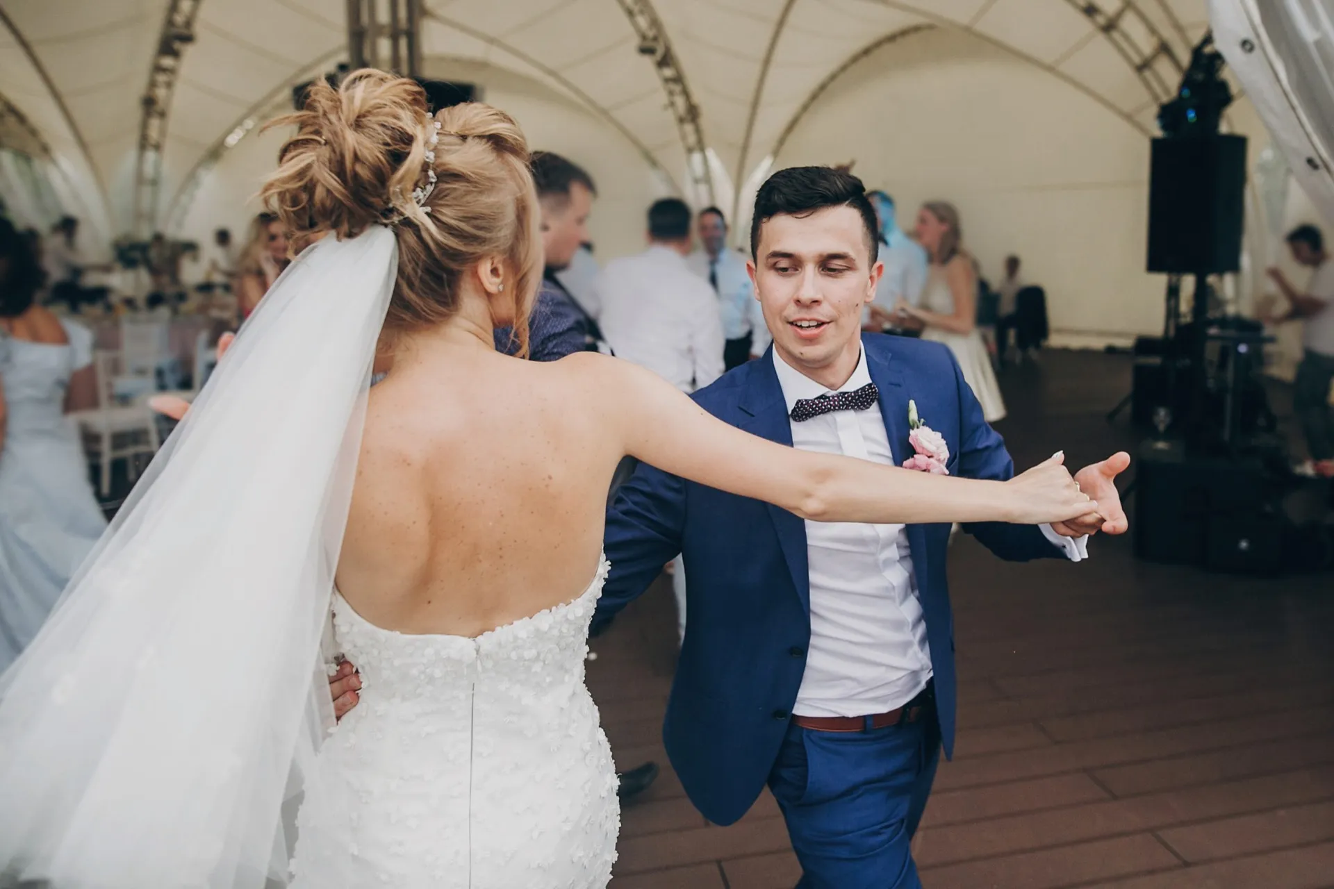 Happy bride and groom dancing together at their wedding reception